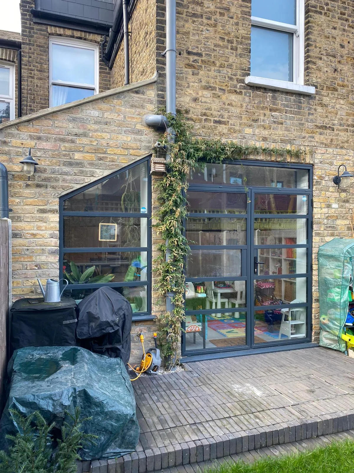 Completed rear extension with Crittall-style glass doors and patio