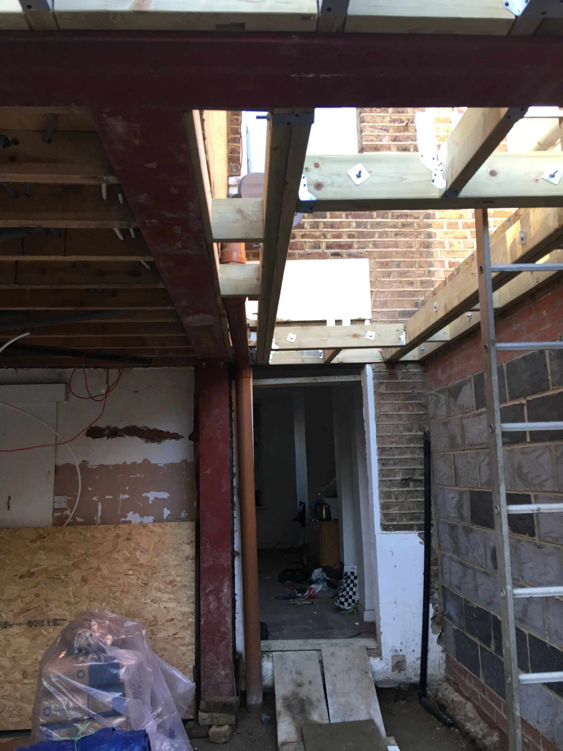 Interior structural framing with timber stud walls and steel beams