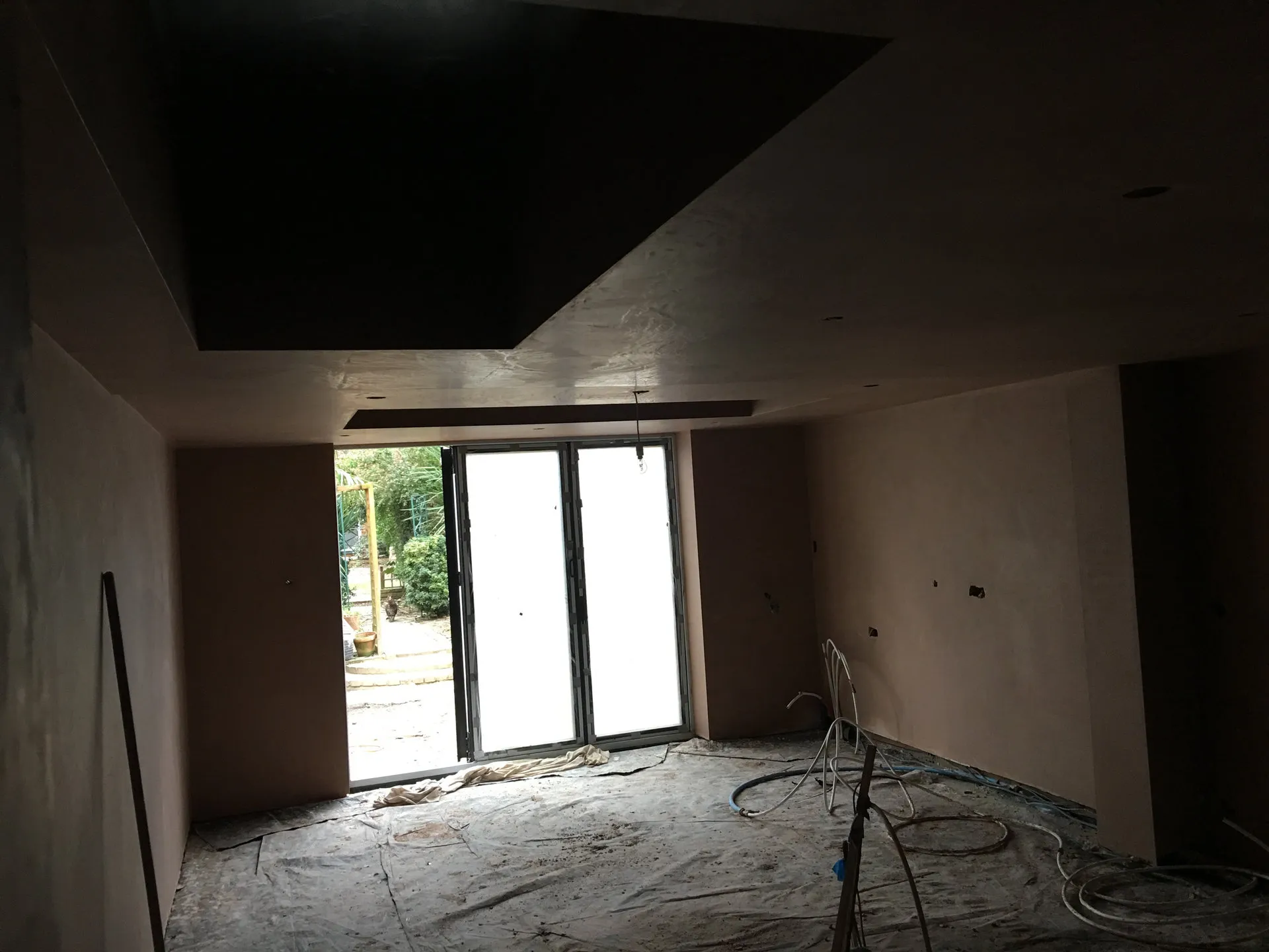 Freshly plastered shell with new bifold doors, ready for fit-out