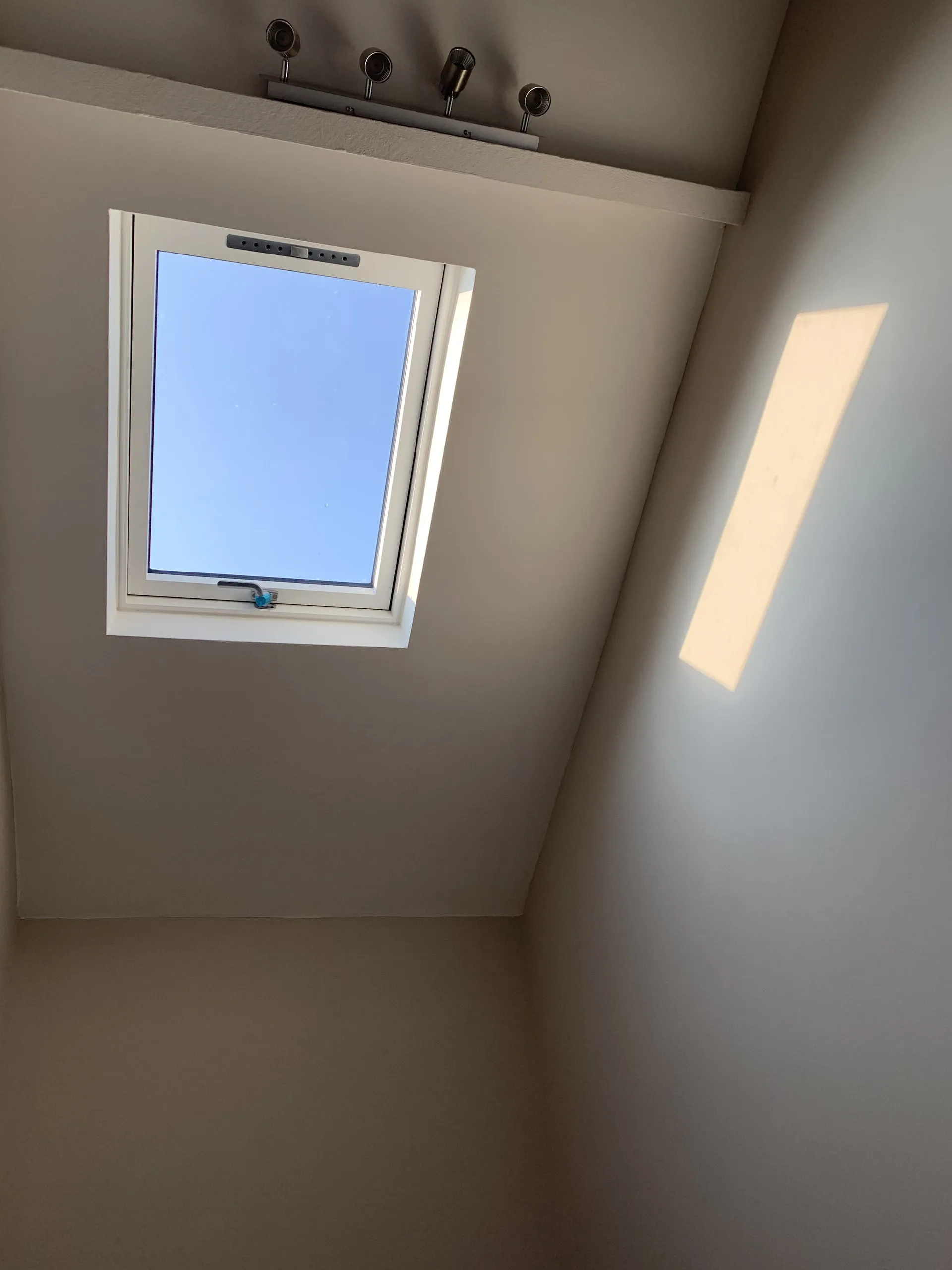 Bright finished room with rooflight and clean microcement floor